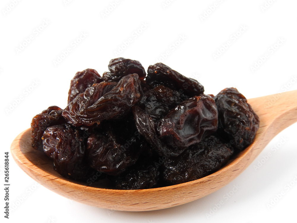 High angle view of raisins on wooden spoon isolated on white background. A raisin is a dried grape Dry food. It tastes sweet and delicious. Texture detail of raisin surface. Food concept. High angle view of raisins on wooden spoon isolated on white background. A raisin is a dried grape Dry food. It tastes sweet and delicious. Texture detail of raisin surface. Food concept.
