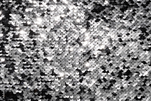 Sequin fabric background. Close-up shot of glittery black sequins texture