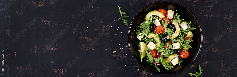 Green salad with sliced avocado, cherry tomatoes, black olives and cheese. Healthy diet vegetarian summer vegetable salad. Table setting. Food concept. Banner. Top view. - obrazy, fototapety, plakaty 