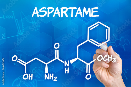 Fotografie Hand with pen drawing the chemical formula of aspartame