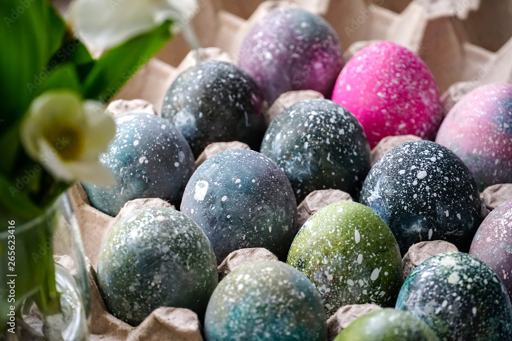 Boiled Easter eggs painted in the style of cosmos and a distant galaxy, against the backdrop of an antique tree and a beautiful flower. Easter. Boiled Easter eggs painted in the style of cosmos and a distant galaxy, against the backdrop of an antique tree and a beautiful flower. Easter.