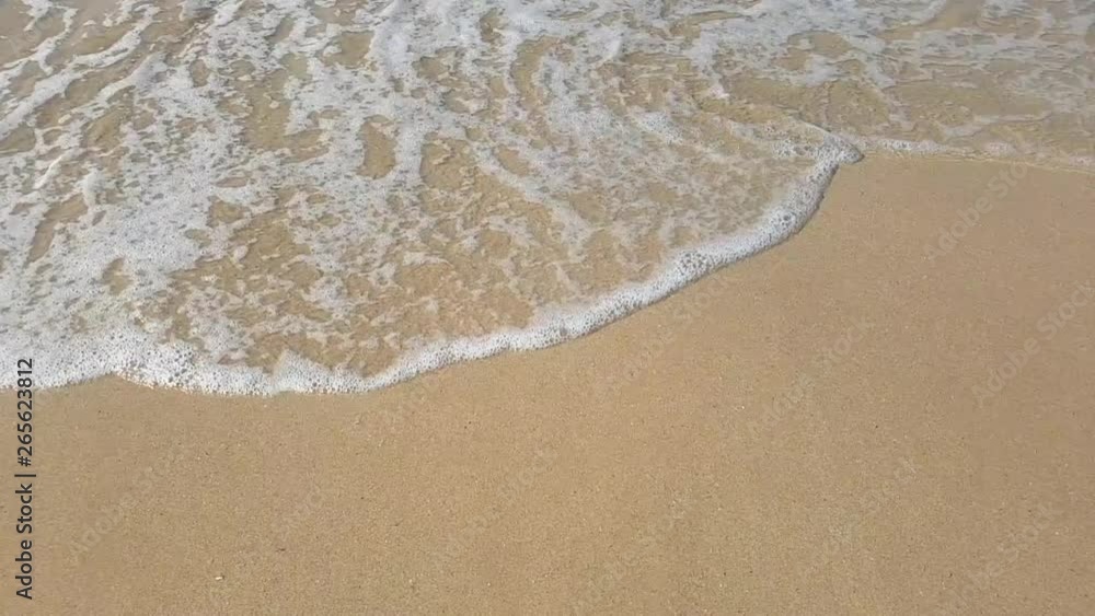 Aerial view. Closeup of waves on the sandy beach making white foam. Aerial view to tropical beach. Aerial view. Closeup of waves on the sandy beach making white foam. Aerial view to tropical beach.