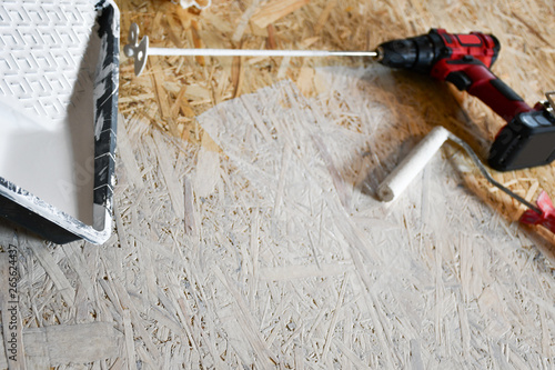 osb plate painted with white paint with a roller