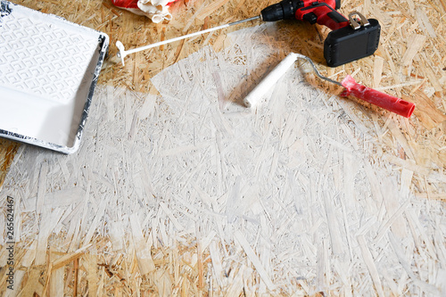 osb plate painted with white paint with a roller