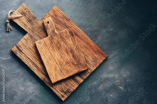Two rustic wooden cutting board on a gray background. Top view, flat lay, copy space.