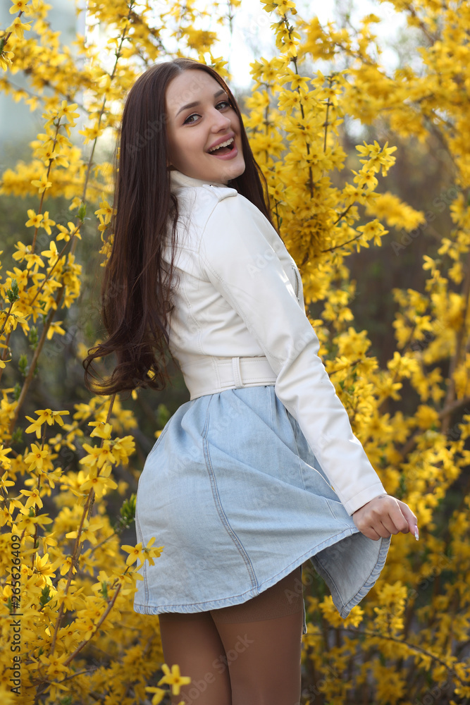 Young girl posing at the bush with spring flowers Young girl posing at the bush with spring flowers