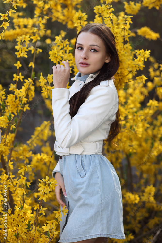 Young girl posing at the bush with spring flowers Young girl posing at the bush with spring flowers