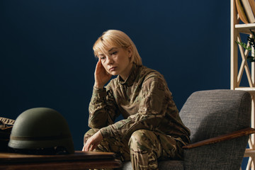 Close up portrait of young female soldier. Woman in military uniform on the war. In doctor's consultation, depressed and having problems with mental health and emotions, PTSD, rehabilitation.