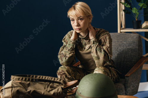 Close up portrait of young female soldier. Woman in military uniform on the war. In doctor's consultation, depressed and having problems with mental health and emotions, PTSD, rehabilitation. © master1305