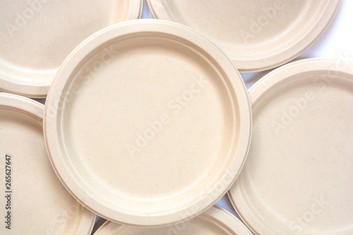 Stack of natural plant paper plates isolated on white background. Plastic free concept. Copy space