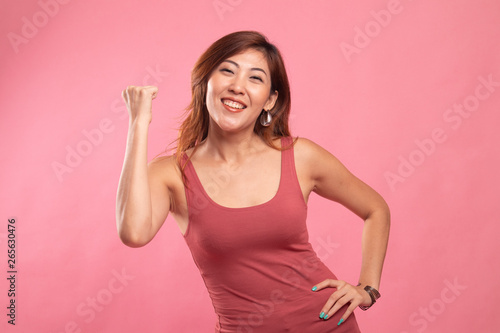Successful  young Asian woman hold fist up.