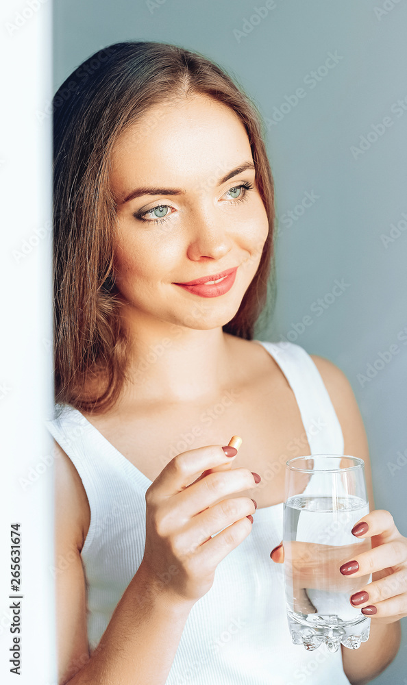 Beautiful Smiling Woman Taking Vitamin Pill. Dietary Supplement Beautiful Smiling Woman Taking Vitamin Pill. Dietary Supplement