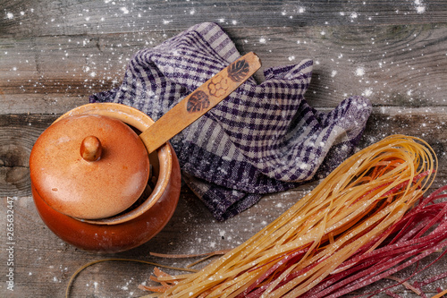 A lot of spaghetti on a wooden table. photo
