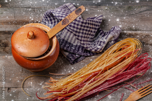 A lot of spaghetti on a wooden table. photo