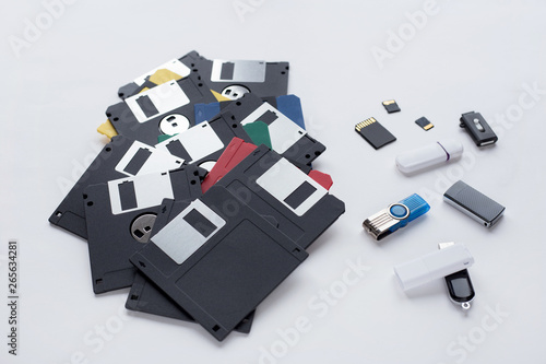 The evolution of digital data storage device. Floppy disks, flash drives and memory cards isolated on white background. photo