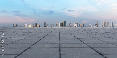 Panoramic empty concrete floor and skyline with buildings