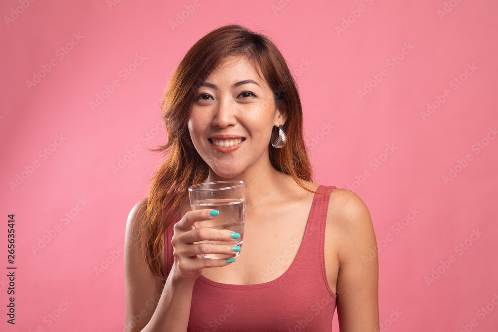 Young Asian woman with a glass of drinking water. Young Asian woman with a glass of drinking water.