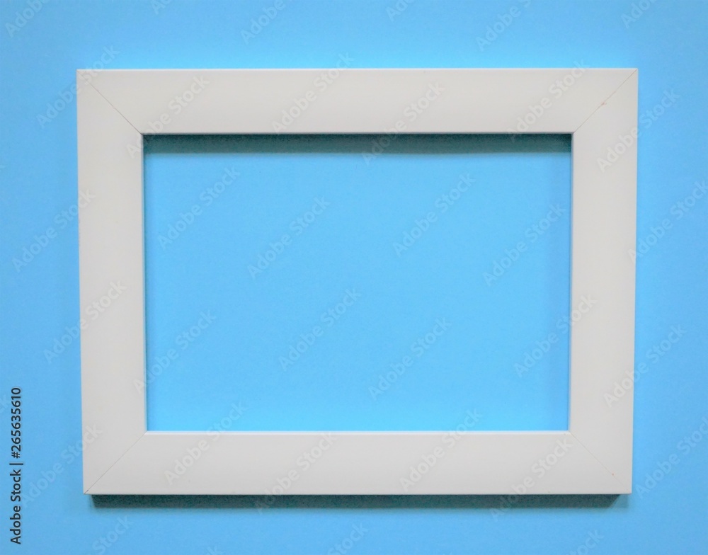 empty picture frame on blue background empty picture frame on blue background
