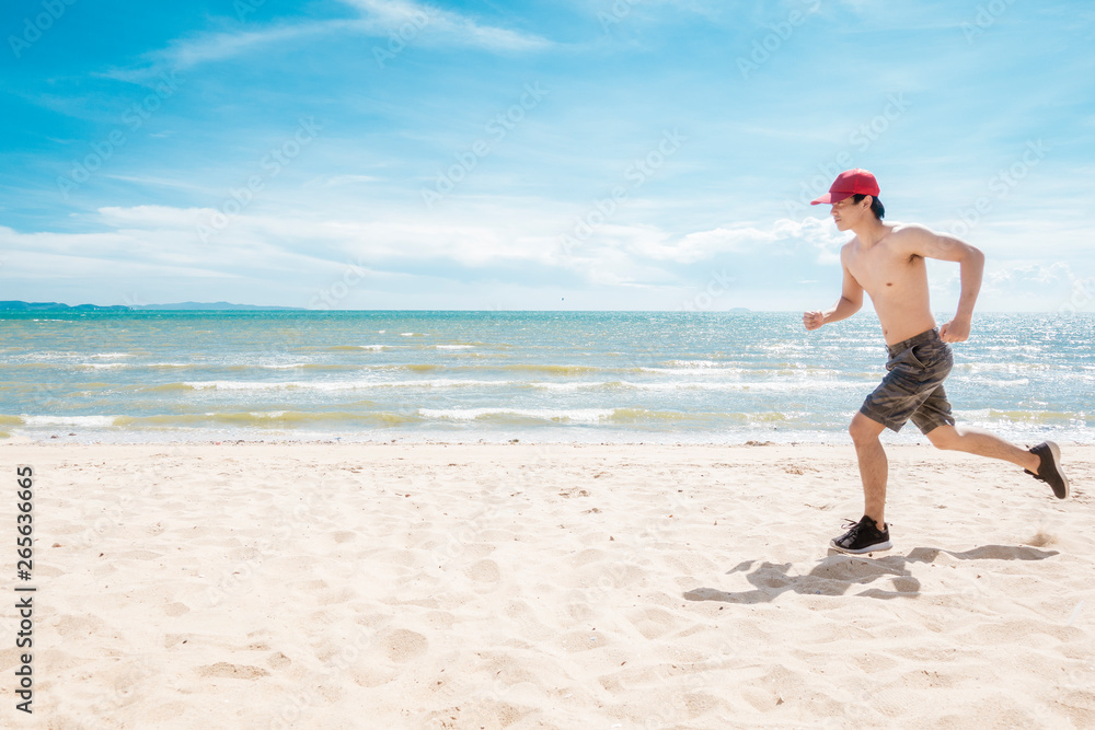 Muscular man is running on the beach Muscular man is running on the beach