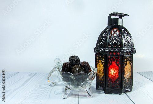 Ramadan lantern and dry dates against white background. 