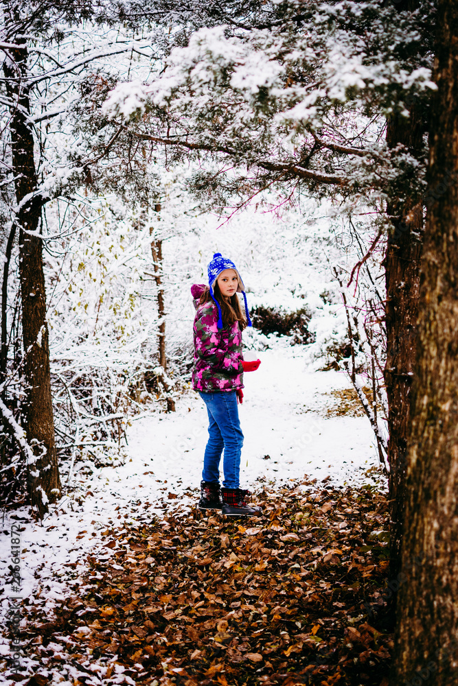 Girl Walking in a Snow Covered Woods