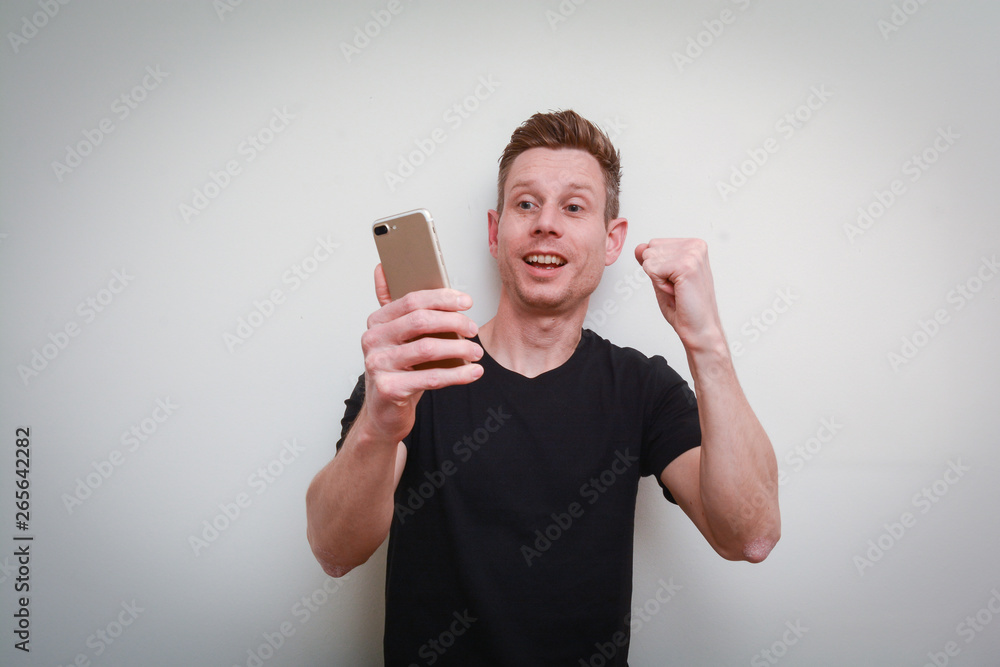 Good news! The man is happy for good news on his phone Good news! The man is happy for good news on his phone