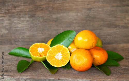  Ripe oranges and leaves on a wooden table, separate on the old wooden floor, sour fruit