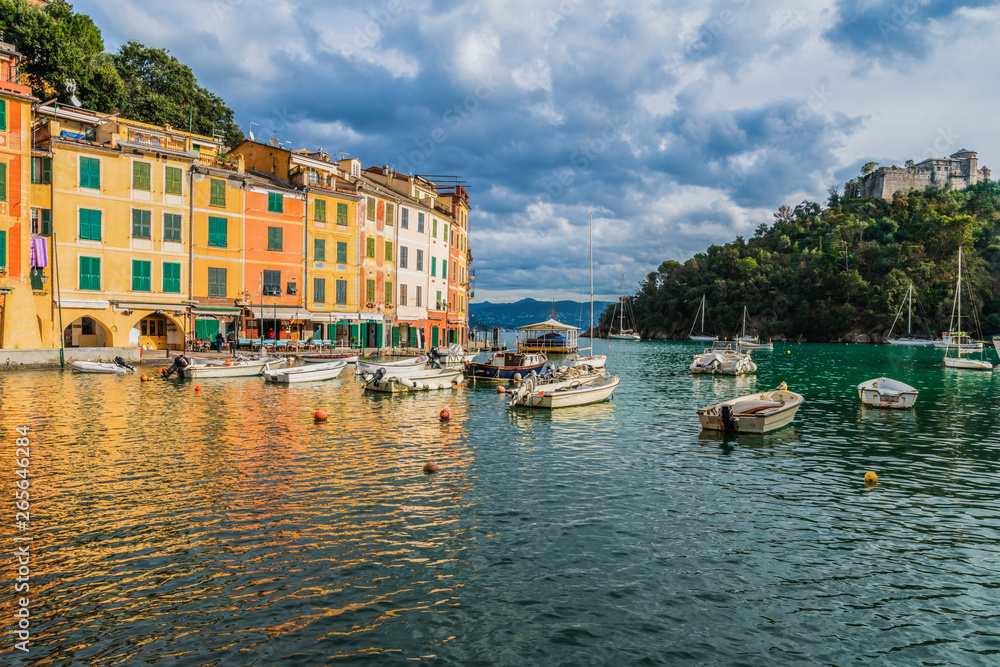 Colorful houses and boats on water in the scenic bay of Portofino in Liguria region, Italy