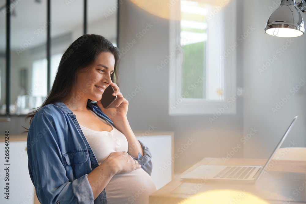 Pregnant woman working from home with laptop Pregnant woman working from home with laptop