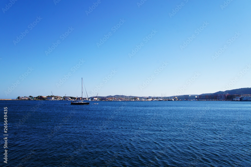 Yacht club with snow-white ships on the pier in the lagoon in the port.