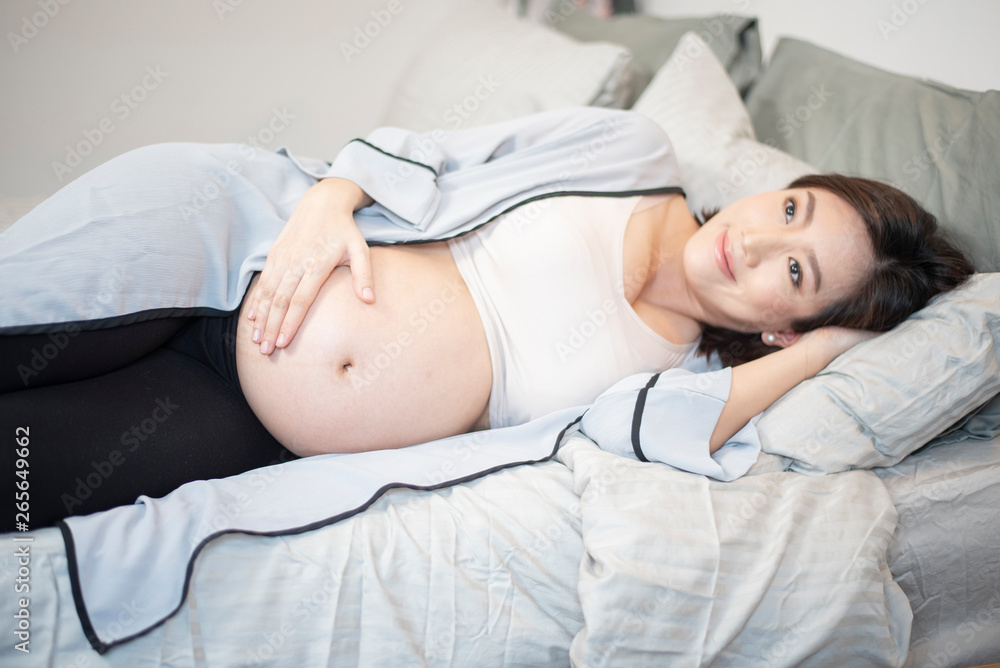 Beautiful asian pregnant woman is sleeping on bed Beautiful asian pregnant woman is sleeping on bed