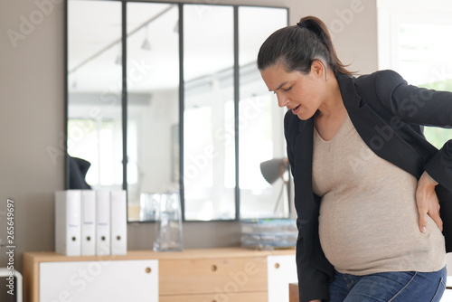 Pregnant businesswoman feeling sick in office