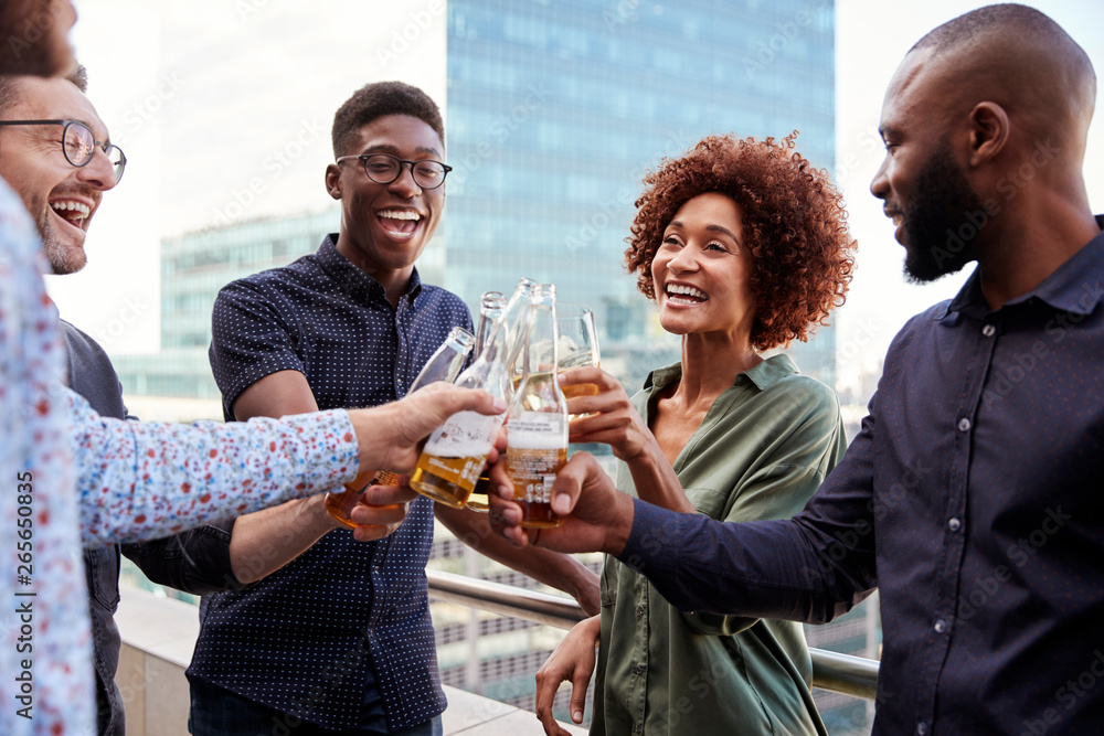 © Monkey Business - Smiling creative business colleagues drinking after work raising glasses to make a toast © Monkey Business - Smiling creative business colleagues drinking after work raising glasses to make a toast