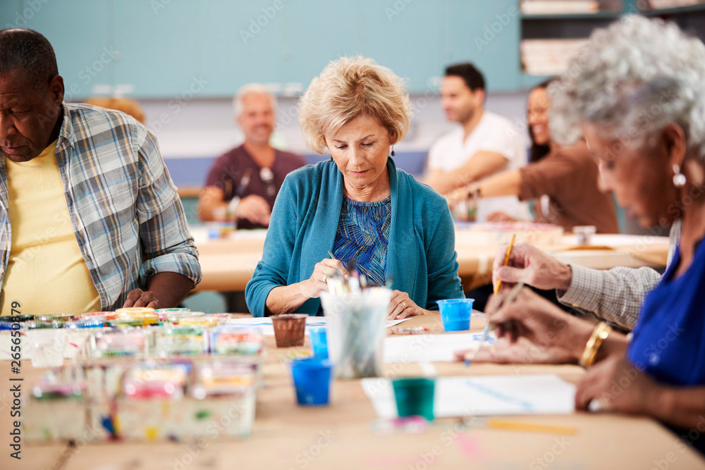 Fototapeta premium Group Of Retired Seniors Attending Art Class In Community Centre With Teacher