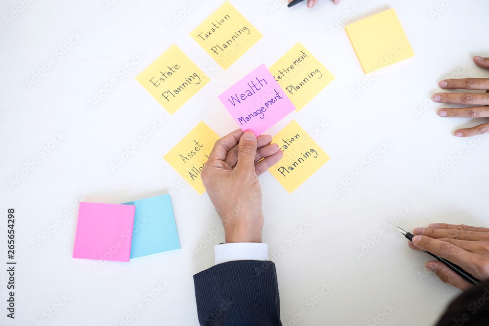 Wealth Management and financial concept, Team of Business accounting analyzing and calculation on valuation data investment fund and looking at report, sticky note paper and having a discussion Wealth Management and financial concept, Team of Business accounting analyzing and calculation on valuation data investment fund and looking at report, sticky note paper and having a discussion