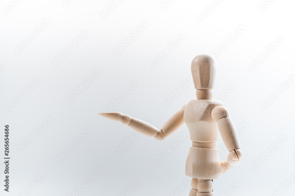 Wooden dummy proudly presents some invisible thing, isolated on white background, copy space for your object or text Wooden dummy proudly presents some invisible thing, isolated on white background, copy space for your object or text