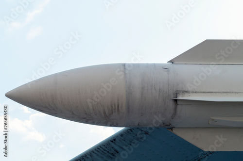 combat missile under the wing of the aircraft close-up against the sky