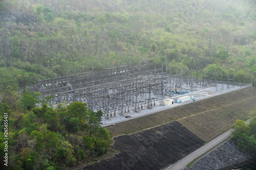 Row of electric pole on power plant in tropical rainforest