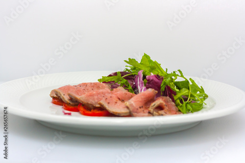 baked ham cut into thin pieces, with spices, lettuce and tomato general view