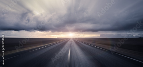 Road leading towards sunset with motion blur effect