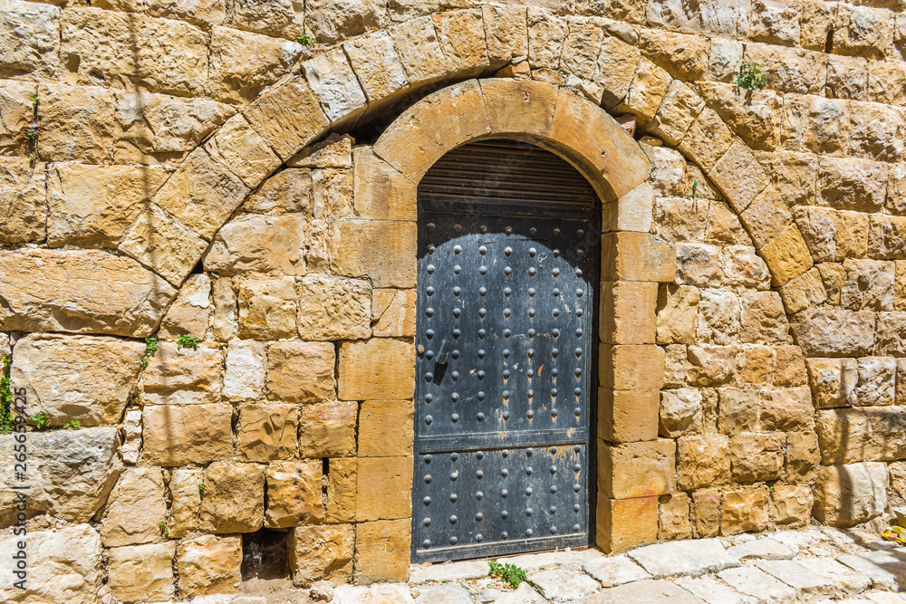 This is a capture of the old roads in Der El Kamar a village Located in Lebanon and you can see in the picture the old walk made of stones with an historic architecture for walls and houses 