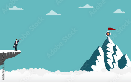 Businessman holding a binocular standing on cliff looking go to target on top of mountain