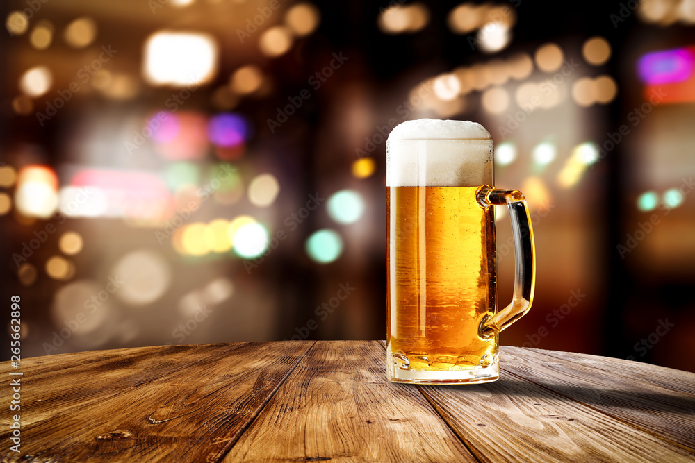 Fresh cold beer in glass and free space for your bottle. Bar interior background Fresh cold beer in glass and free space for your bottle. Bar interior background