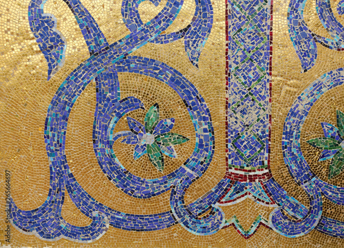 Mosaic fragment. Floral ornament blue on a golden background.