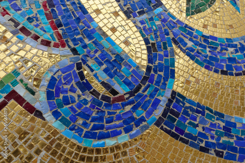 Photography Mosaic fragment. Floral ornament blue on a golden background.