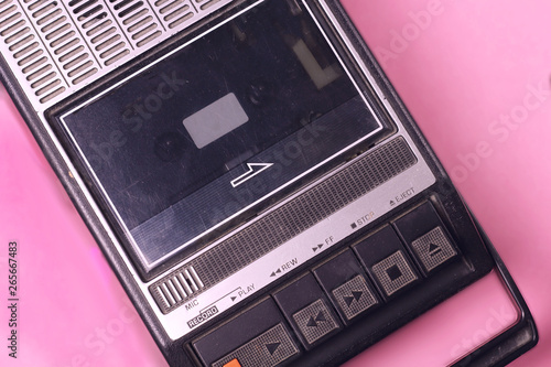 Old retro vintage 70s, 80s, 90s style portable  audio  tape cassette  recorder radio  on a pink background top view