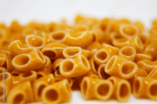 lots of uncooked macaroni on white background