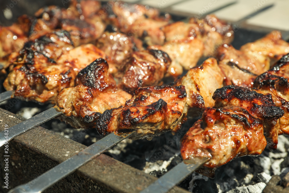 Meat skewers on grill as background, closeup. Outdoor kitchen