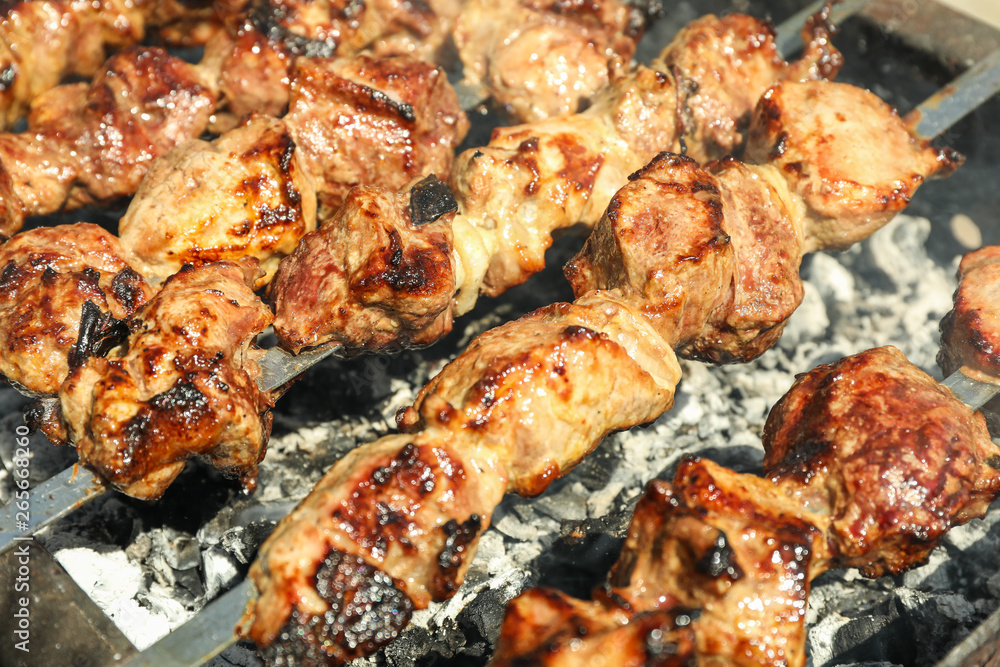 Meat skewers on grill as background, closeup. Outdoor kitchen