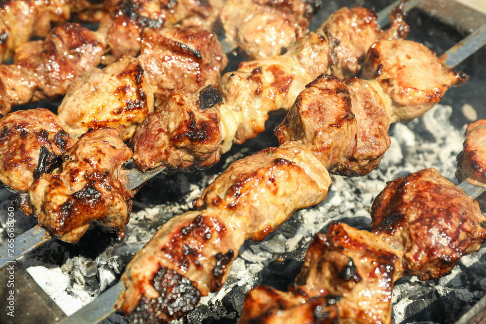 Meat skewers on grill as background, closeup. Outdoor kitchen Meat skewers on grill as background, closeup. Outdoor kitchen